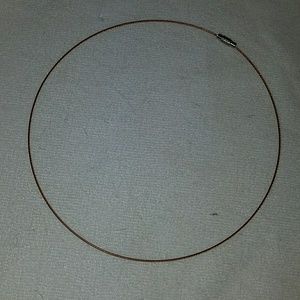 Brown twisted wire choker with silver closure.